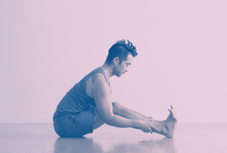 A man in Seated Forward Bend, a stretch for tight hamstrings