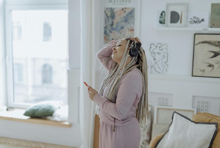 Image of woman with headphones on in robe getting ready for the day.