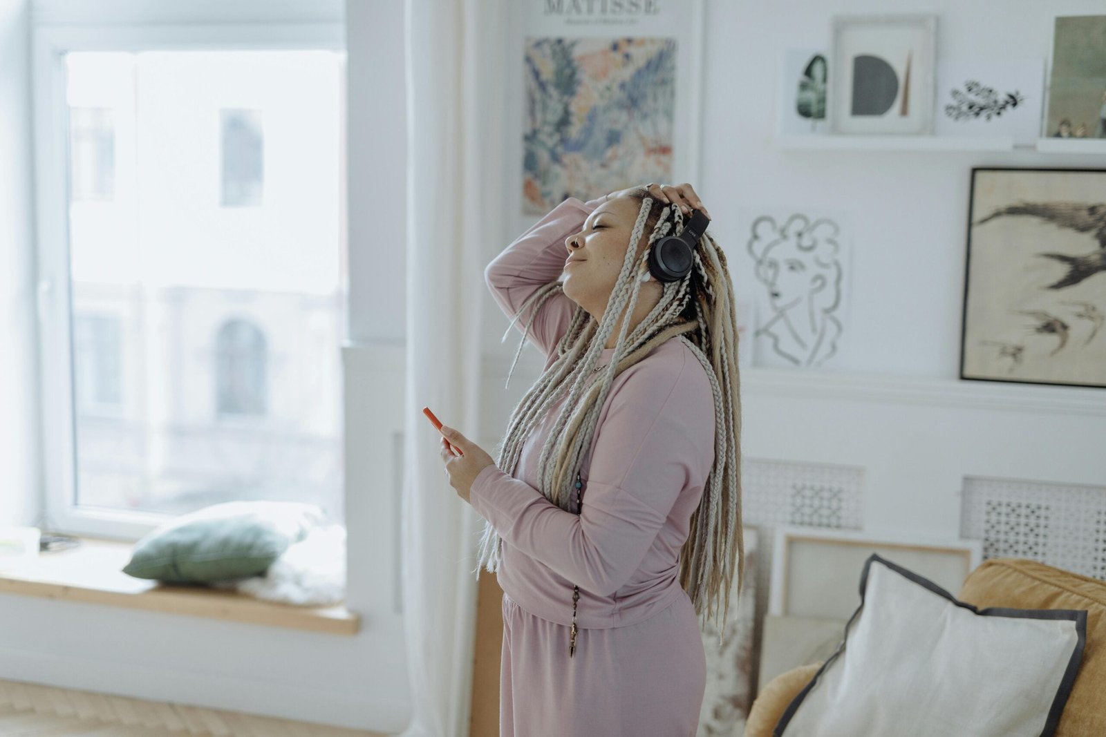 Image of woman with headphones on in robe getting ready for the day.