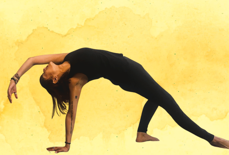 Woman practicing Wild Thing against a yellow watercolor backdrop