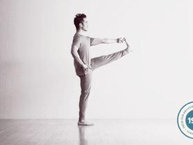 Man in a standing balancing pose with his hand reaching for his lifted foot in Utthita Hasta Padangusthasana