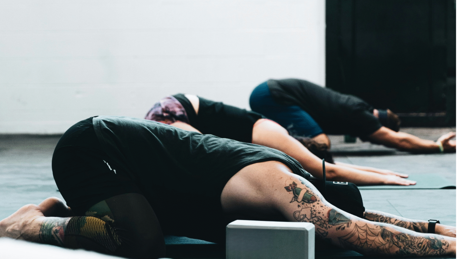 Yoga in Spanish class with students in Child's Pose