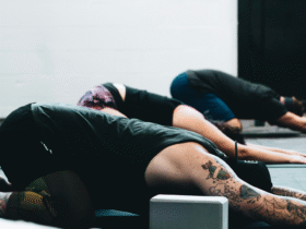 Yoga in Spanish class with students in Child's Pose