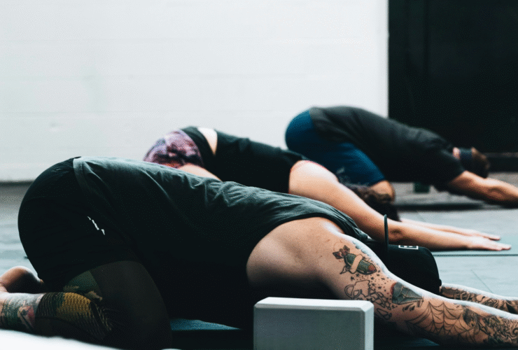 Yoga in Spanish class with students in Child's Pose
