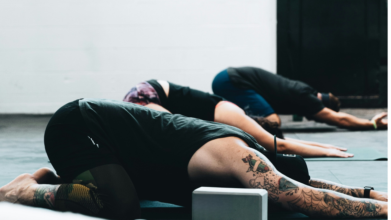 Yoga in Spanish class with students in Child's Pose