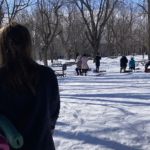 Woman standing in front of a snowga class in a park in Montreal