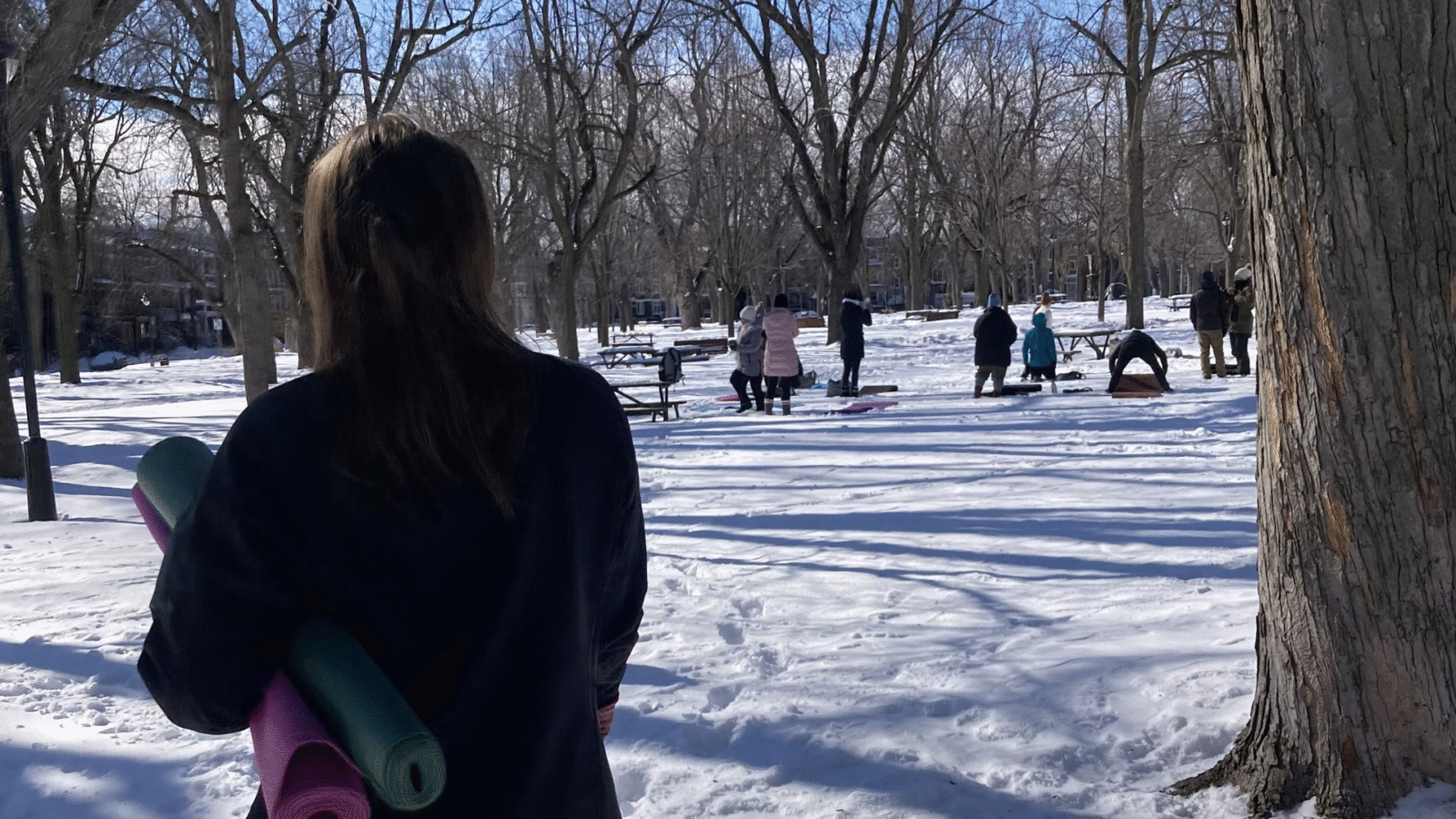 Woman standing in front of a snowga class in a park in Montreal