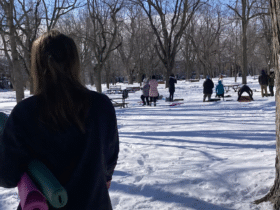 Woman standing in front of a snowga class in a park in Montreal