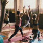 A yoga class practicing high lunge in a studio