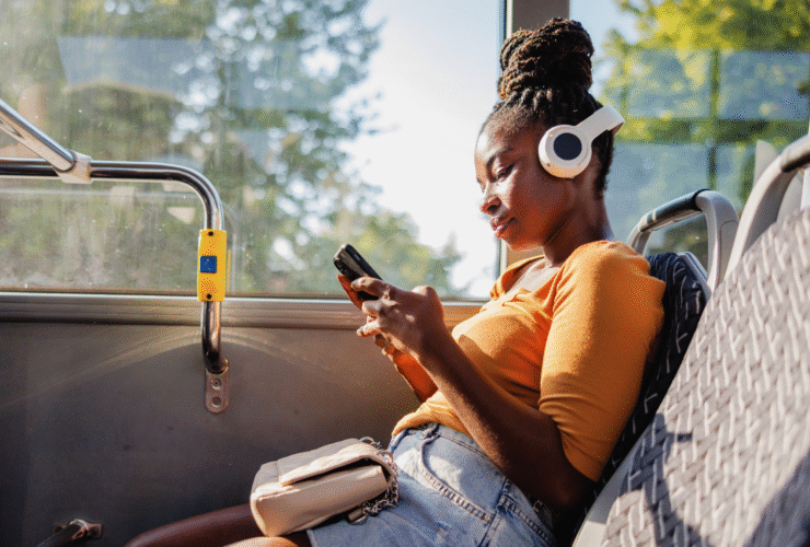 A woman using her phone on a bus