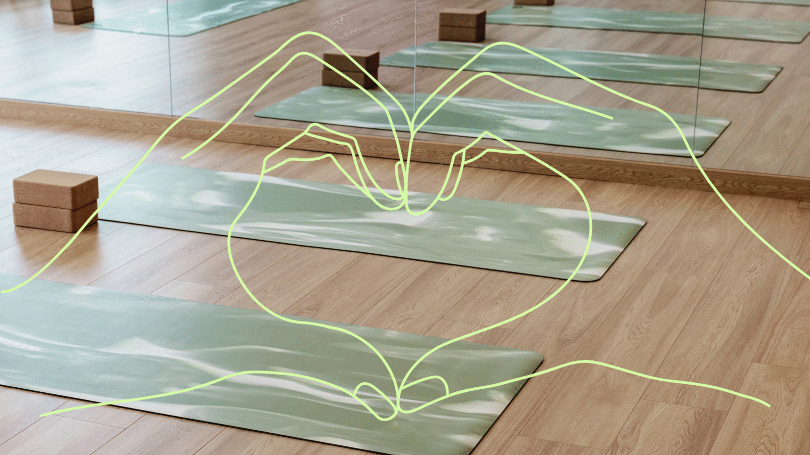 Heart hands over the backdrop of an empty yoga studio