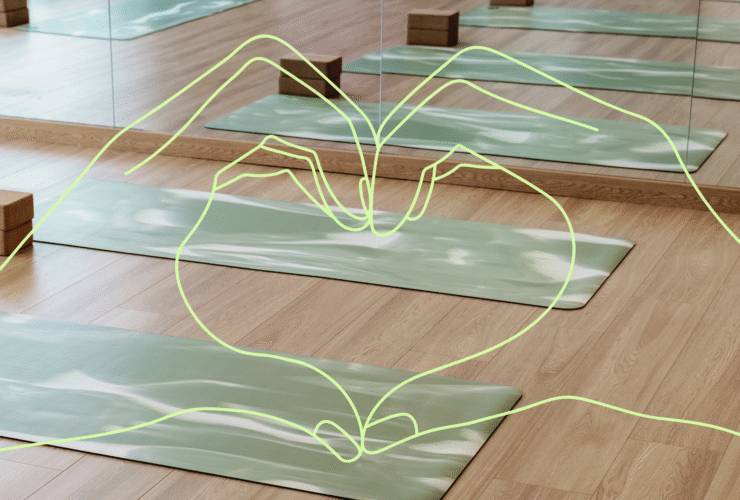 Heart hands over the backdrop of an empty yoga studio
