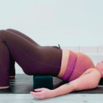 Yoga teacher Taylor Lorenz in Supported Reclined Butterfly Pose, part of her yin yoga for energy practice