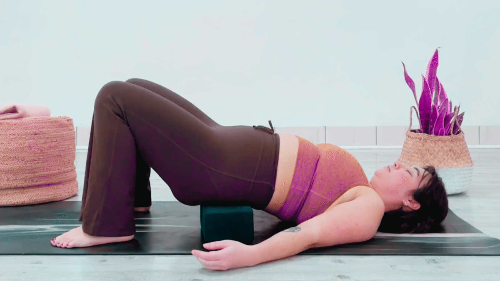 Yoga teacher Taylor Lorenz in Supported Reclined Butterfly Pose, part of her yin yoga for energy practice