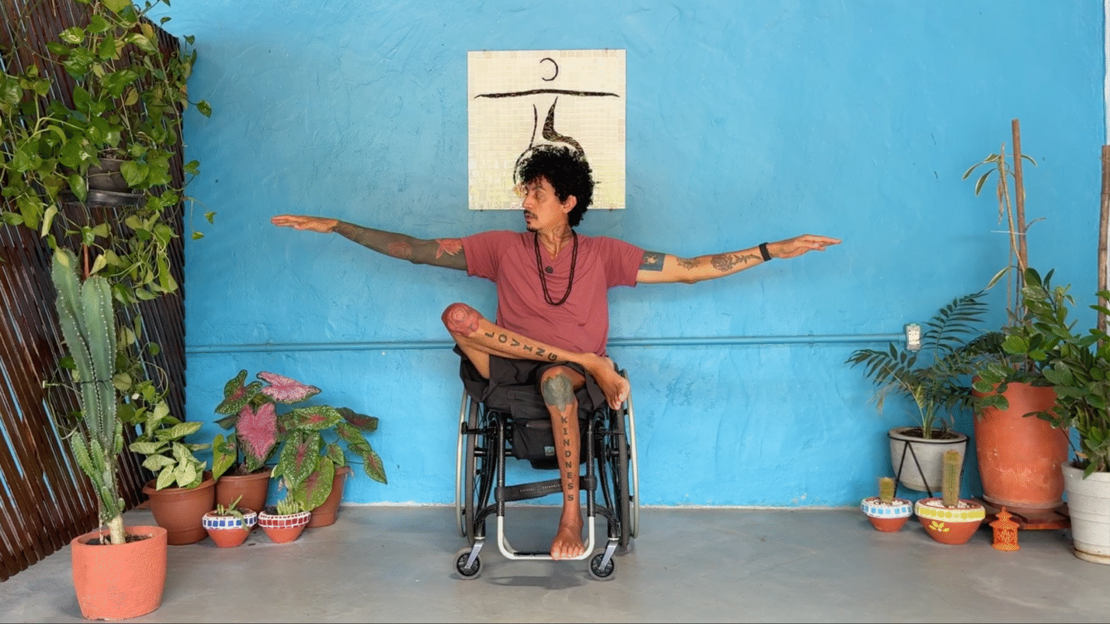 Yoga teacher in a chair in an adaptive yoga Warrior 2