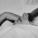 Woman resting in bed after doing yoga for sleep.