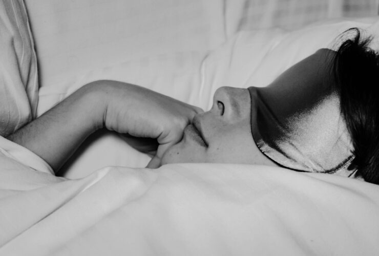 Woman resting in bed after doing yoga for sleep.
