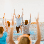 Yoga class led by Pedro Luna on a beach in Florida as he's learning how to become a yoga teacher who leads students authentically