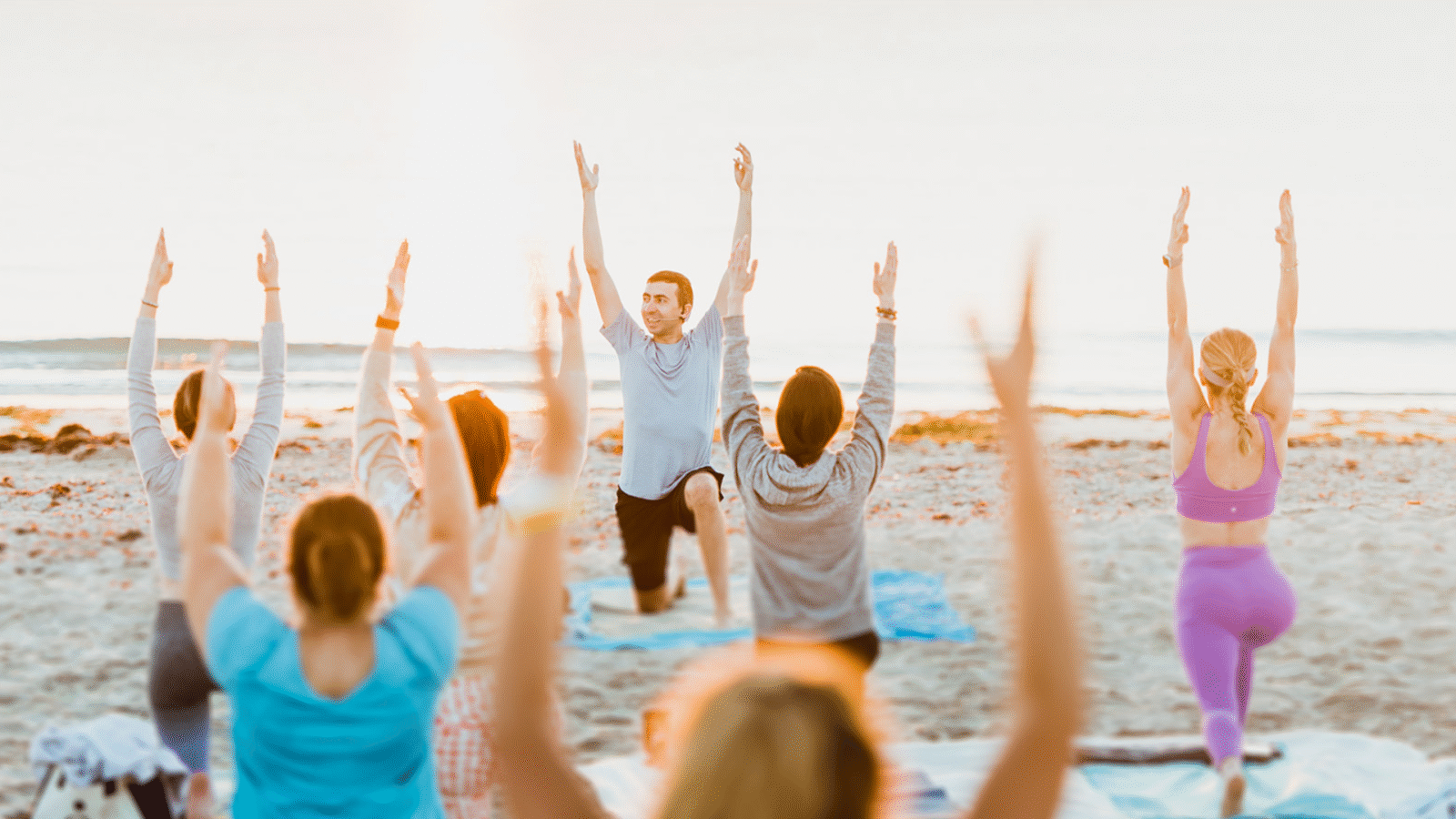 Yoga class led by Pedro Luna on a beach in Florida as he's learning how to become a yoga teacher who leads students authentically