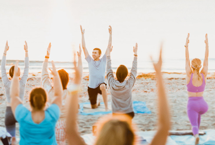 Yoga class led by Pedro Luna on a beach in Florida as he's learning how to become a yoga teacher who leads students authentically