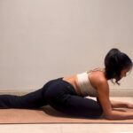 Yoga instructor doing pigeon pose.