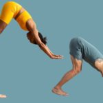 A man and a woman in variations of Downward-Facing Dog