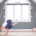 Woman leaning forward into the arm balance known as Flying Pigeon Pose