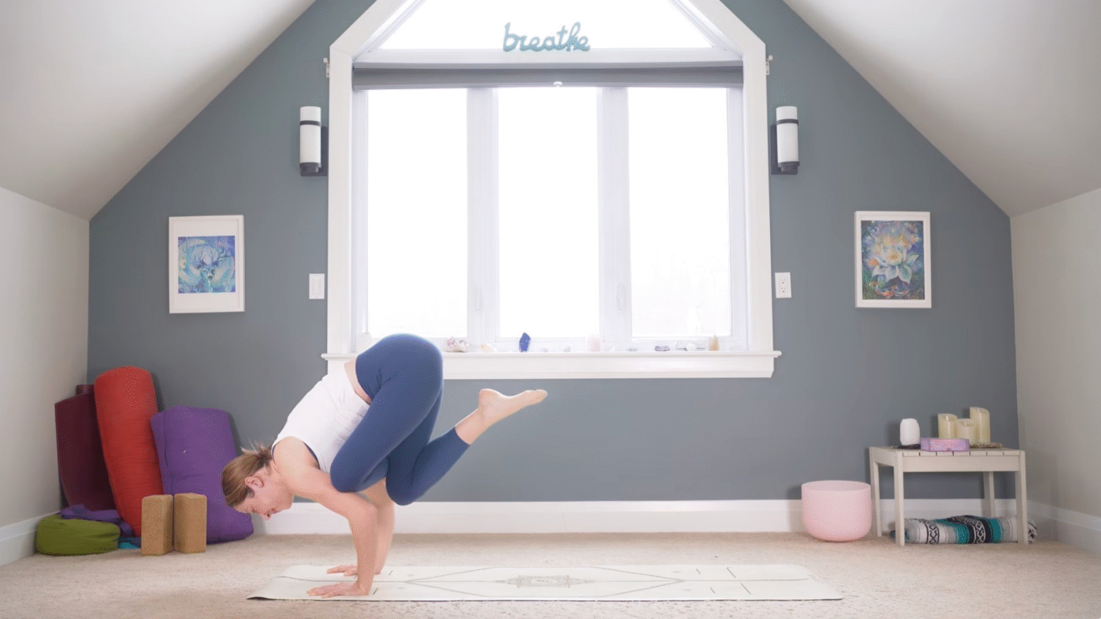 Woman leaning forward into the arm balance known as Flying Pigeon Pose