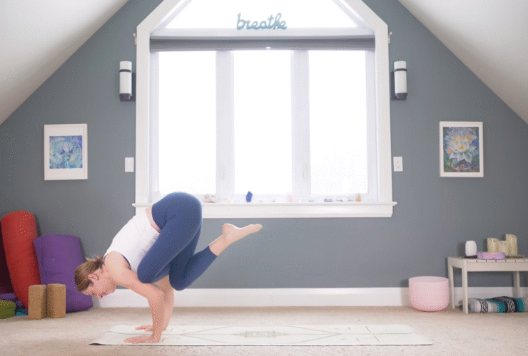 Woman leaning forward into the arm balance known as Flying Pigeon Pose