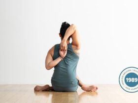 Man practicing Cow Face pose.