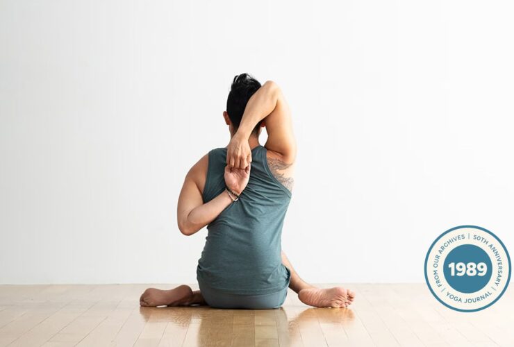 Man practicing Cow Face pose.