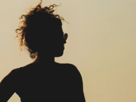 Silhouette of a woman at sunset considering the weekly horoscope for April 26-May 2, 2026.