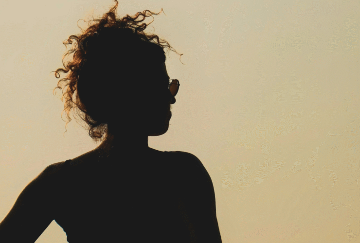 Silhouette of a woman at sunset considering the weekly horoscope for April 26-May 2, 2026.