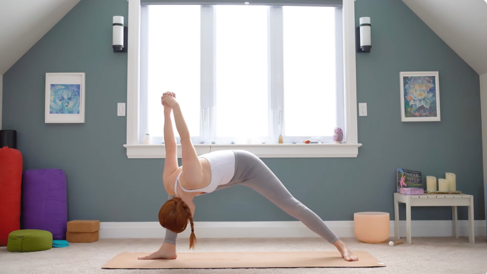 Woman leaning forward in Humble Warrior with her hands clasped behind her back