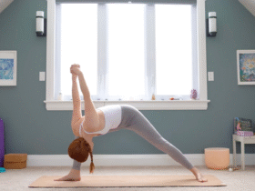 Woman leaning forward in Humble Warrior with her hands clasped behind her back