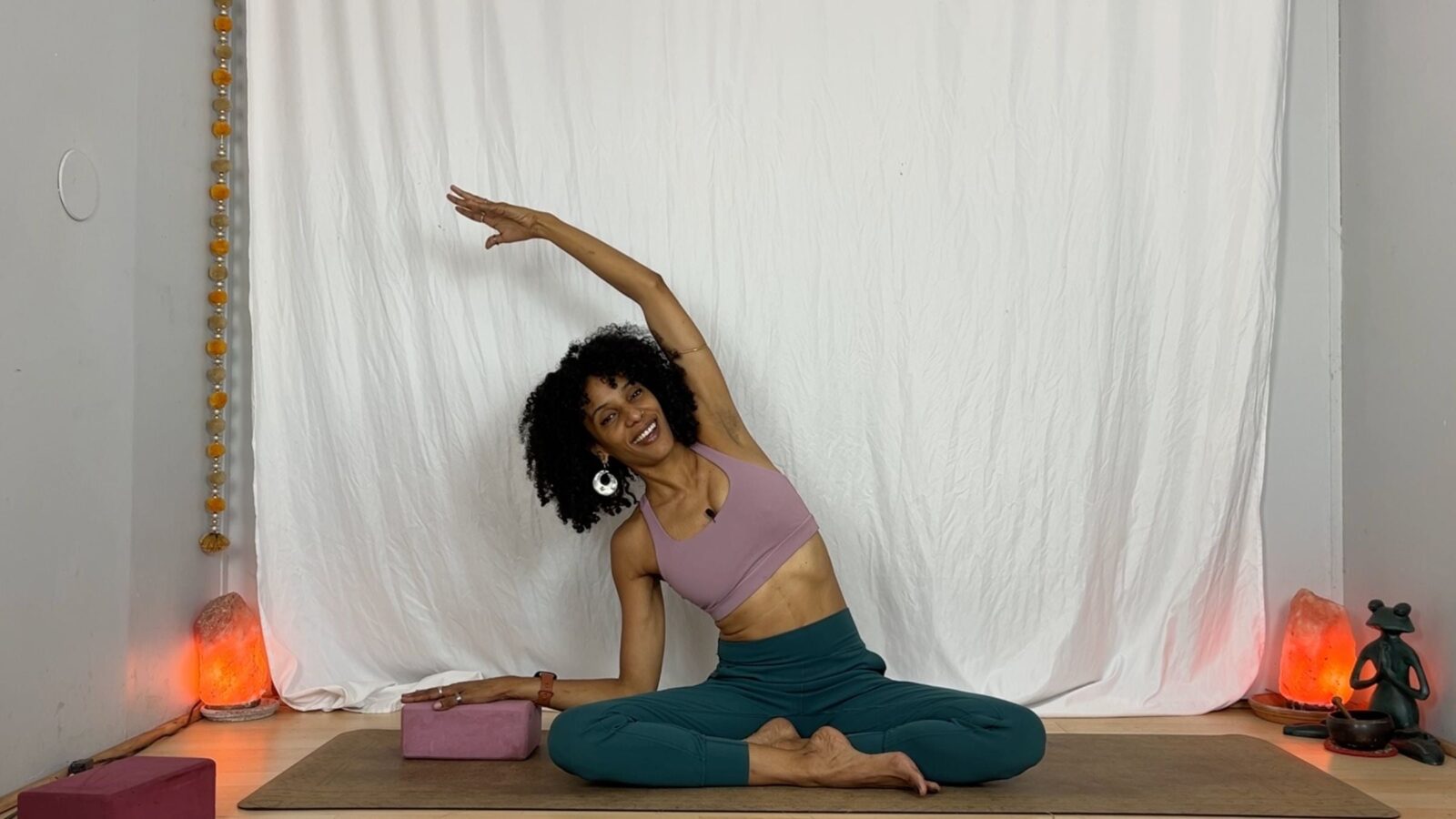 Yoga instructor practicing seated side stretch.
