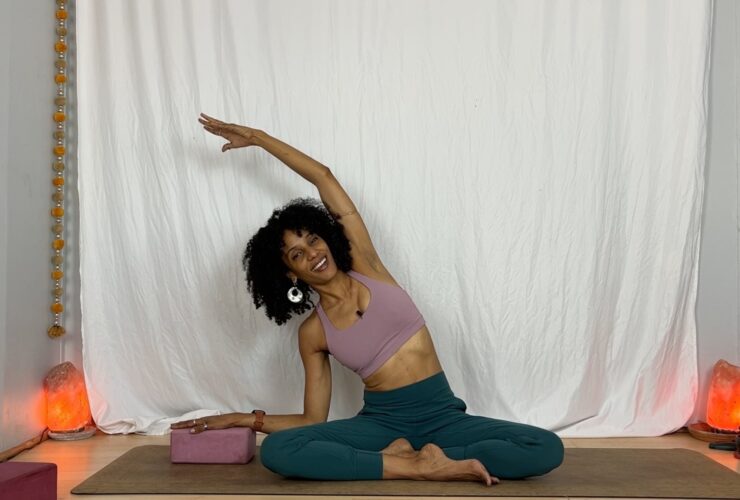 Yoga instructor practicing seated side stretch.