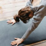 Woman practicing Downward Facing Dog for tight shoulders.