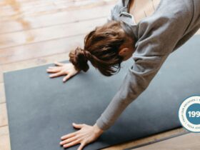 Woman practicing Downward Facing Dog for tight shoulders.