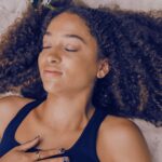 Woman practicing Ujjayi breath in nature.