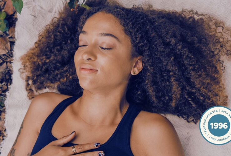Woman practicing Ujjayi breath in nature.
