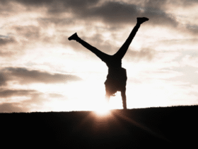 Woman turning cartwheels against a backdrop of the sunset